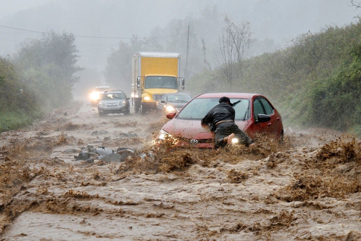 People struggling to escape on a flooded highway